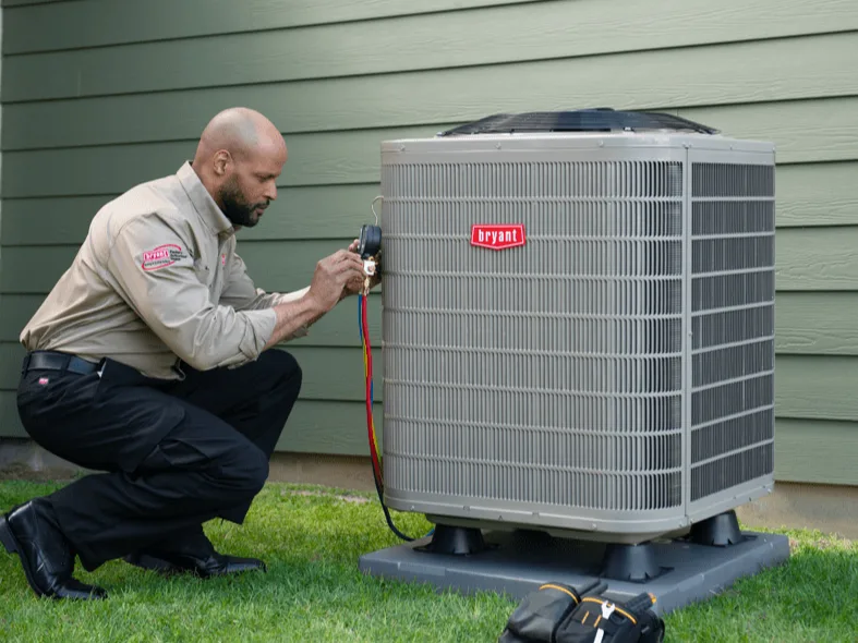 A Bryant technician checks the charge on a newly set air conditioner